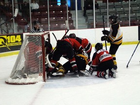 An intense scramble during the second period of the game on Sunday, Nov.2, between the Bantam Thistles and the Holland Rockets where all of the players, but not the puck ended up in Kenora's net.