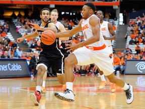 Ron Patterson #4 of the Syracuse Orange dribbles the ball up the court in front of Philip Scrubb #23 of Carleton Ravens during the second half at the Carrier Dome on November 2, 2014 in Syracuse, New York. Syracuse defeated Carleton 76-68.  Rich Barnes/Getty Images/AFP