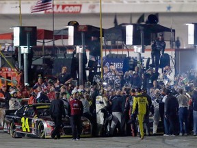 Brad Keselowski, driver of the #2 Miller Lite Ford, and Jeff Gordon, driver of the #24 Drive To End Hunger Chevrolet, are involved in a fight at the conclusion of the NASCAR Sprint Cup Series AAA Texas 500 at Texas Motor Speedway on November 2, 2014 in Fort Worth, Texas.   (Tom Pennington/Getty Images for Texas Motor Speedway/AFP)