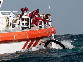 Rescuers retrieve a boat that sank off the Black Sea village of Garipce near Istanbul November 3, 2014. Rescuers pulled 24 dead bodies from the sea at the mouth of Istanbul's Bosphorus strait on Monday and rescued seven people after the boat carrying a group of migrants sank, the Turkish Coastguard Command said. Seven coastguard vessels and a helicopter were continuing search operations in the Black Sea, some 5 km north of the Bosphorus, the coastguard said in a statement. Media reports said some 40 illegal migrants, including children, were believed to have been on the boat. REUTERS/Osman Orsal