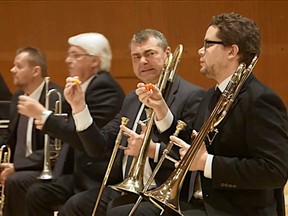 The Danish National Chamber Orchestra eats a variety of extremely hot peppers and continues to play. 
(Screenshot from YouTube)