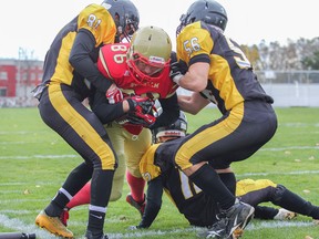 It took three LaSalle Black Knights, Jordan Price, Sam Mace and Will Shorthouse to stop Sydenham Golden Eagles Sam Moyse during a running play in the first quarter of the Kingston Area Secondary School Athletic Association Senior Football AA Championship game at Richardson Stadium on Saturday November 1, 2014. The Golden Eagles won 47-0. Julia McKay/Kingston Whig-Standard/QMI Agency