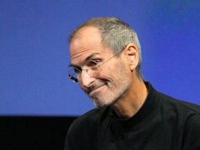 Steve Jobs smiles during a Q&A session at the end of the iPhone OS4 special event at Apple headquarters in Cupertino, Calif., in this April 8, 2010, file photo.  REUTERS/Robert Galbraith