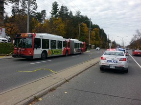 An OC Transpo bus sits at the scene of a fatal crash involving a pedestrian on Monday morning, Nov. 3, 2014, along Baseline Rd. near Rockway. (DOUG HEMPSTEAD Ottawa Sun)