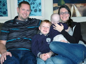 Cam, left, Seth and Sarah West gather together on a couch in their St. Thomas home. Cam and Sarah were foster parents to Seth, 7, when he was a baby and later adopted him. The couple is currently fostering another child, pictured, but they asked he not be identified.
(Ben Forrest, Times-Journal)