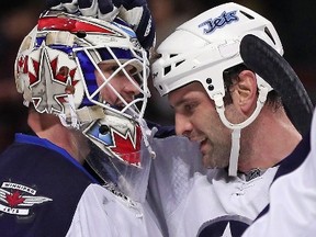 Michael Hutchinson is congratulated by Mark Stuart after a shutout win against the Chicago Blackhawks. The Jets are receiving the best goaltending they've received since moving to Winnipeg from Atlanta. (Jonathan Daniel/Getty Images/AFP)