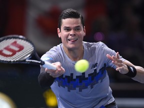 Canada's Milos Raonic returns the ball to Serbia's Novak Djokovic during the final match at the ATP World Tour Masters 1000 indoor tennis tournament on November 2, 2014 at the Bercy Palais-Omnisport (POPB) in Paris. (AFP PHOTO / FRANCK FIFE)