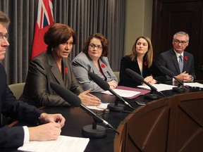 Dissenting Manitoba NDP cabinet ministers (l-r) Andrew Swan, Theresa Oswald, Jennifer Howard, Erin Selby and Stan Struthers speak at a news conference Monday Nov. 3, 2014.