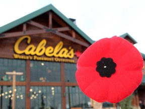 A poppy is held up outside Cabela's, 15320 - 37 Street, in Edmonton Alta., on Sunday Nov. 2, 2014. Apparently the store in north Edmonton recently asked a group of cadets selling poppies to leave. David Bloom/Edmonton Sun