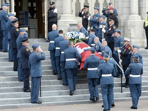 Submitted photo by Cpl. Nedia Countinho 
Quinte West firefighter Robert Comeau was a member of the honorary guard that lined the steps of  St-Antoine-De-Padoue Cathedral in Longueuil, Quebec for the funeral of Warrant Officer Patrice Vincent on Saturday, Nov. 1, 2014. Comeau was a close personal friend. He can be seen at the top step, saluting and wearing a navy blue firefighters dress uniform.