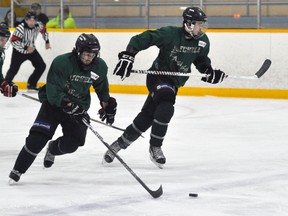 Mitchell Hawks’ Jerry Ennett (14) and Adam Zehr break out of their own zone with the puck during Western Jr. C hockey action at home Saturday, Nov. 1 to Kincardine. The Bulldogs handed the locals a 5-2 loss. ANDY BADER/MITCHELL ADVOCATE