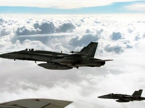 Royal Canadian Air Force CF-18 Hornets depart after refueling with a  KC-135 Stratotanker assigned to the 340th Expeditionary Air Refueling Squadron over Iraq, Oct. 30, 2014. (STAFF SGT. PERRY ASTON/U.S. Air Force/Handout via Reuters)