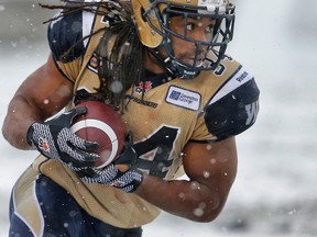 Winnipeg Blue Bombers Paris Cotton runs the ball against the Calgary Stampeders on Saturday. (Al Charest/QMI Agency)