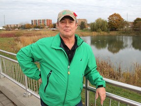 Chris Hall stands in front of the area along Gardiners Road next to the Lions Civic Gardens where a new apartment building may be built. (Michael Lea/The Whig-Standard)
