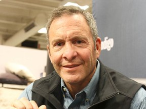Clint Malarchuk poses with a copy of a book at a recent event in Calgary. (Jim Wells, Q!MI Agency)