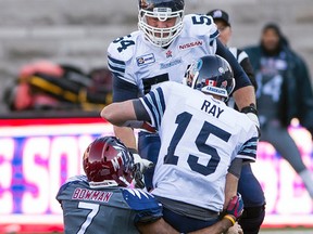 Argos QB Ricky Ray is taken down hard by John Bowman of the Alouettes during Toronto’s 17-14 loss in Montreal on Sunday. Ray had to leave the game and his status remains unclear. (Joel LeMay/QMI Agency)
