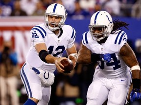 Andrew Luck of the Indianapolis Colts hands the ball off to Trent Richardson in the in the first quarter against the New York Giants during their game at MetLife Stadium on November 3, 2014. (Jeff Zelevansky/Getty Images/AFP)