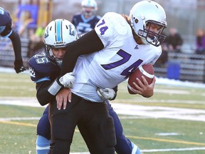 Gino Donato/The Sudbury Star
St. Benedict Bears Joshua Girolametto takes down Lo-Ellen Knights Michael Favot during senior boys high school football semifinal action from James Jerome Field on Monday afternoon.
