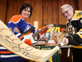 Shauna Larkin, project coordinator, and David Black, executive producer, show off some of the great items available for auction in the 2014 ATCO Edmonton Sun Christmas Charity Auction at the Christmas Bureau of Edmonton in Edmonton, Alta., on Monday, Nov. 3, 2014. The auction benefits the Christmas Bureau of Edmonton,  Stollery Children's Hospital Foundation, the United Way of the Alberta Capital Region and Catholic Social Services Sign of Hope. Ian Kucerak/Edmonton Sun/ QMI Agency