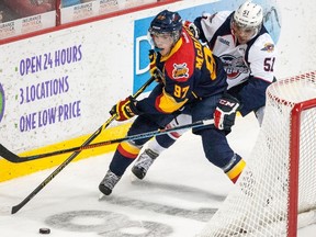 Connor McDavid #97 of the Erie Otters moves the puck against Jalen Chatfield #51 of the Windsor Spitfires on September 26, 2014 at the WFCU Centre in Windsor, Ontario, Canada. (GETTY IMAGES/AFP)