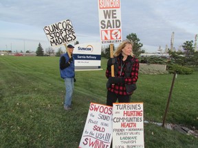 Ed Vanderaa and Mary-Lynn Cooper were among approximately a half dozen local residents who demonstrated Monday outside the Suncor refinery in Sarnia to protest the company's plan to build wind turbines in Lambton County. A provincial tribunal is set to begin hearing an appeal of the province's environmental approval for the wind project. (PAUL MORDEN, The Observer)
