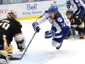 Evan De Haan, middle, of the Sudbury Wolves, is tripped up as he breaks to the net durig OHL action at the Sudbury Community Arena on Friday, Oct. 31, 2014. (JOHN LAPPA/THE SUDBURY STAR/QMI AGENCY)