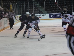 Canada White's Luke Green carries the puck into USA territory with Keenan Suthers chasing after him. Team USA won Friday's exhibition game 6-0. (TERRY BRIDGE/THE OBSERVER)