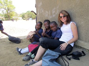 Carleen Green, right, sits with some of the children she worked with on a recent trip to Zambia, Africa. Green spent two weeks there with an African non-governmental organization.  (Contributed photo)