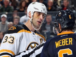 Zdeno Chara #33 of the Boston Bruins has words with Mike Weber #6 of the Buffalo Sabres at First Niagara Center on October 18, 2014 in Buffalo, New York.  (Jen Fuller/Getty Images/AFP)