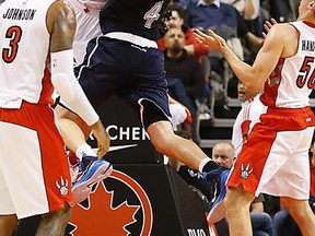 Raptors’  Greg Stiemsma lowers the boom on the Thunder’s Nick Collison at the ACC last night. Stiemsma was called for a flagrant foul.
