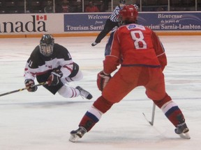 Russian defenceman Dmitri Alexeyev watches Canada White forward Jordan Kyrou go airborne after being tripped up near the Russian blue line. Canada White and Russia played their third and final preliminary World Under-17 Hockey Challenge round-robin games Tuesday night at RBC Centre in Sarnia. (TERRY BRIDGE/THE OBSERVER)