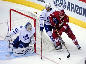 Maple Leafs goalie James Reimer keeps a close eye on Arizona Coyotes winger Rob Klinkhammer at Gila River Arena on Tuesday night. (USA TODAY Sports)