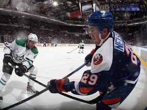 Brock Nelson of the New York Islanders is checked by Brenden Dillon of the Dallas Stars during the second period at the Nassau Veterans Memorial Coliseum on October 25, 2014. (Bruce Bennett/Getty Images/AFP)