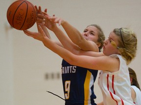 Strathroy Saints Emily Dearlove fights for a rebound with Medway?s Kyra Kruger during their TVRA Central AAA quarterfinal at Medway on Tuesday. Medway came from behind to win 34-31 in overtime. (Mike Hensen/The London Free Press)