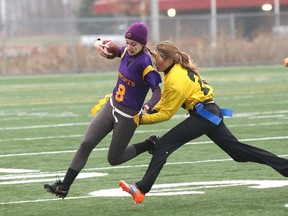 JOHN LAPPA/THE SUDBURY STAR/QMI AGENCY
Alyssa Menard, right, of the Bishop Gators, grabs the flag of Haley Conroy, of the Lo-Ellen Knights, during the girls high school flag football division B championship game at the James Jerome Sports Complex on Tuesday.