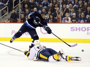 Evander Kane takes a shot on net as Nashville Predators defenceman Roman Josi looks to block during the second period at MTS Centre on Tuesday night. The Jets will host their skills competition on Dec. 17. (Bruce Fedyck-USA TODAY Sports)