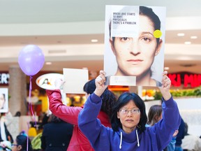 Lois Friesen-Smith takes part in a freeze mob put on by AIDS Niagara and the Brock University Student Justice Centre at the Pen Centre to recognize International Women's Day on March 9, 2013. (Julie Jocsak/QMI Agency)