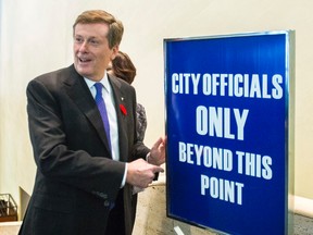 Mayor-elect John Tory jokes with media about being allowed past this sign, after scrumming at City Hall in Toronto on Wednesday, November 5, 2014. (Ernest Doroszuk/Toronto Sun)