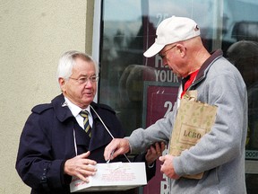Dave Bridge, right, purchases a poppy from the Royal Canadian Legion branch 18's Bill Bechard on Saturday, Nov. 1, outside of the LCBO. A poppy blitz was held across the community on the weekend. The annual Wallaceburg Remembrance Day ceremony will be held at the UAW Hall on Nov, 11, with everyone being asked to be seated for 10:45 a.m.