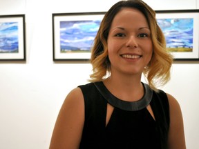 Chantelle Lloyd, a research co-ordinator with the Prevention and Early Intervention Program for Psychoses near some of the artwork in Creative Minds, an exhibition at The ARTS Project on Dundas Street Nov. 4, 2014. CHRIS MONTANINI\LONDONER\QMI AGENCY