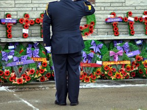 An OPP officer salutes the fallen as he lays a wreath at Remembrance Day services in South Porcupine in 2011. (CHRIS RIBAUQMI AGENCY)