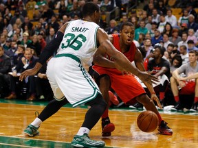 Raptors’ Kyle Lowry works the ball against Celtics’ Marcus Smart in the first quarter at TD Garden in Boston on Wednesday night. (USA TODAY)