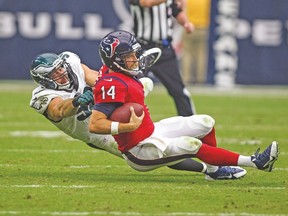 Houston Texans quarterback Ryan Fitzpatrick gets taken down by Philadelphia Eagles outside linebacker Connor Barwin during their game on Sunday. (USA TODAY SPORTS)