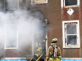 JOHN LAPPA/THE SUDBURY STAR/QMI AGENCY
Firefighters battle a house fire on Alder Street in Sudbury in this file photo.