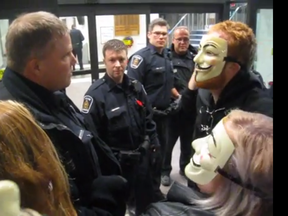 Police and protesters squared off at London city hall Wednesday night. The demonstrators were part of the Million Mask March.