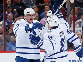 Dion Phaneuf #3 of the Toronto Maple Leafs celebrates with Phil Kessel #81 and Tyler Bozak #42 after Phaneuf scored a second period power play goal against the Arizona Coyotes during the NHL game at Gila River Arena on November 4, 2014 in Glendale, Arizona. (Christian Petersen/Getty Images/AFP)