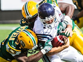 the Eskimos defence, shown here tackling Ricky Ray in August, are looking to restart their streak of games with a sack, ended at 39 the last time the roughriders and Eskimos met two weeks ago. (Codie McLachlan, Edmonton Sun)