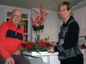 Ian McLay sits in the kitchen of his Aylmer home with decorator Caroline Buis of The Flower Fountain in Aylmer. The McLay home is featured in the upcoming Aylmer-Malahide Museum Volunteers’ 13th Annual Christmas Tour of Homes. Buis is completing floral design for the event. 

Ben Forrest/Times-Journal