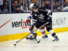 Los Angeles Kings defenceman Slava Voynov (26) battles for the puck with New York Rangers centre Brad Richards during Game 2 of the 2014 Stanley Cup Final at Staples Center. (Gary A. Vasquez/USA TODAY Sports)