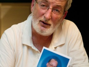 Robert McNamee, holding a card with a photo of Kevin McNamee who died while living in a People Helping People group home on Fleming Dr. (MIKE HENSEN, The London Free Press)